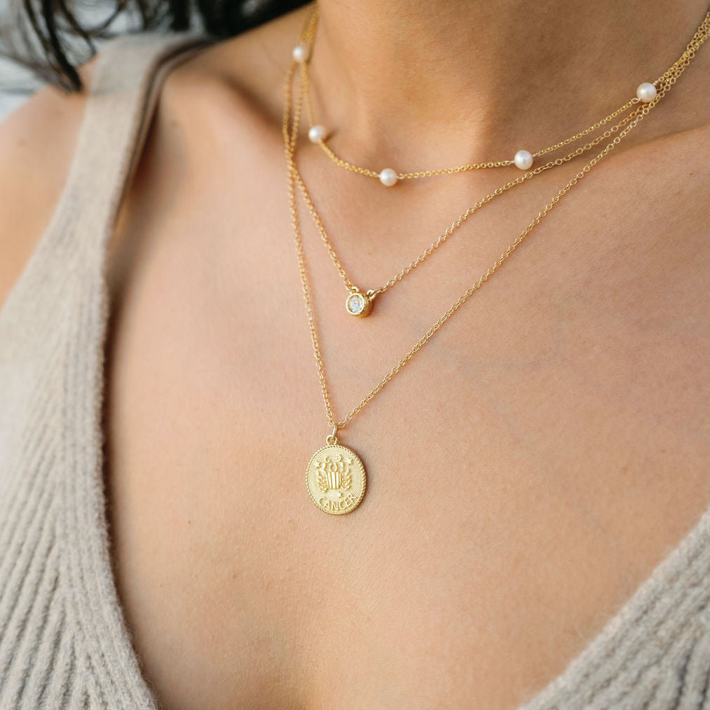Best sellers, dainty delicate layering and stacking jewelry by Katie Dean Jewelry, handmade in America, featuring the Birthstone Necklace, Pearl Necklace and Cancer Zodiac Necklace