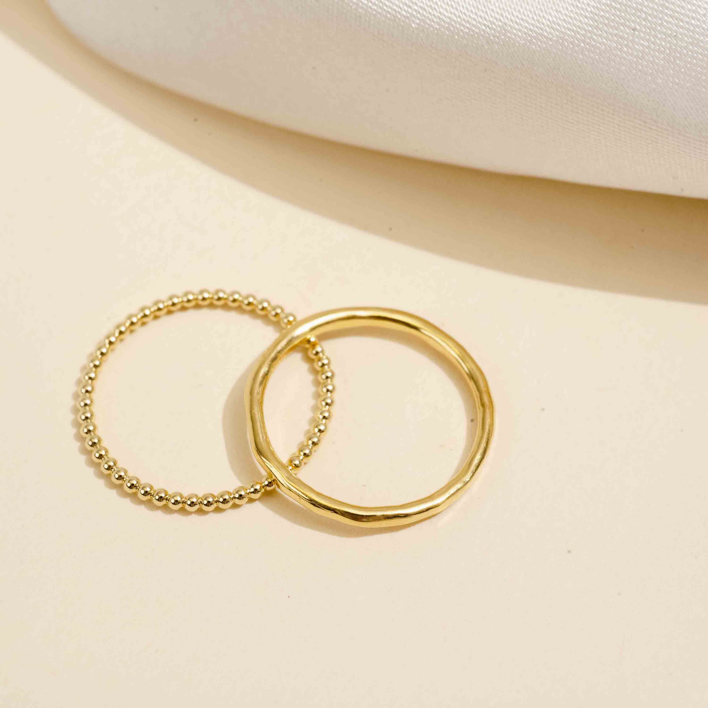 A How-To guide on elevating your everyday style with minimalist jewelry featuring the dainty gold Beaded and Hammered Band stacking ring made in America by Katie Dean Jewelry.