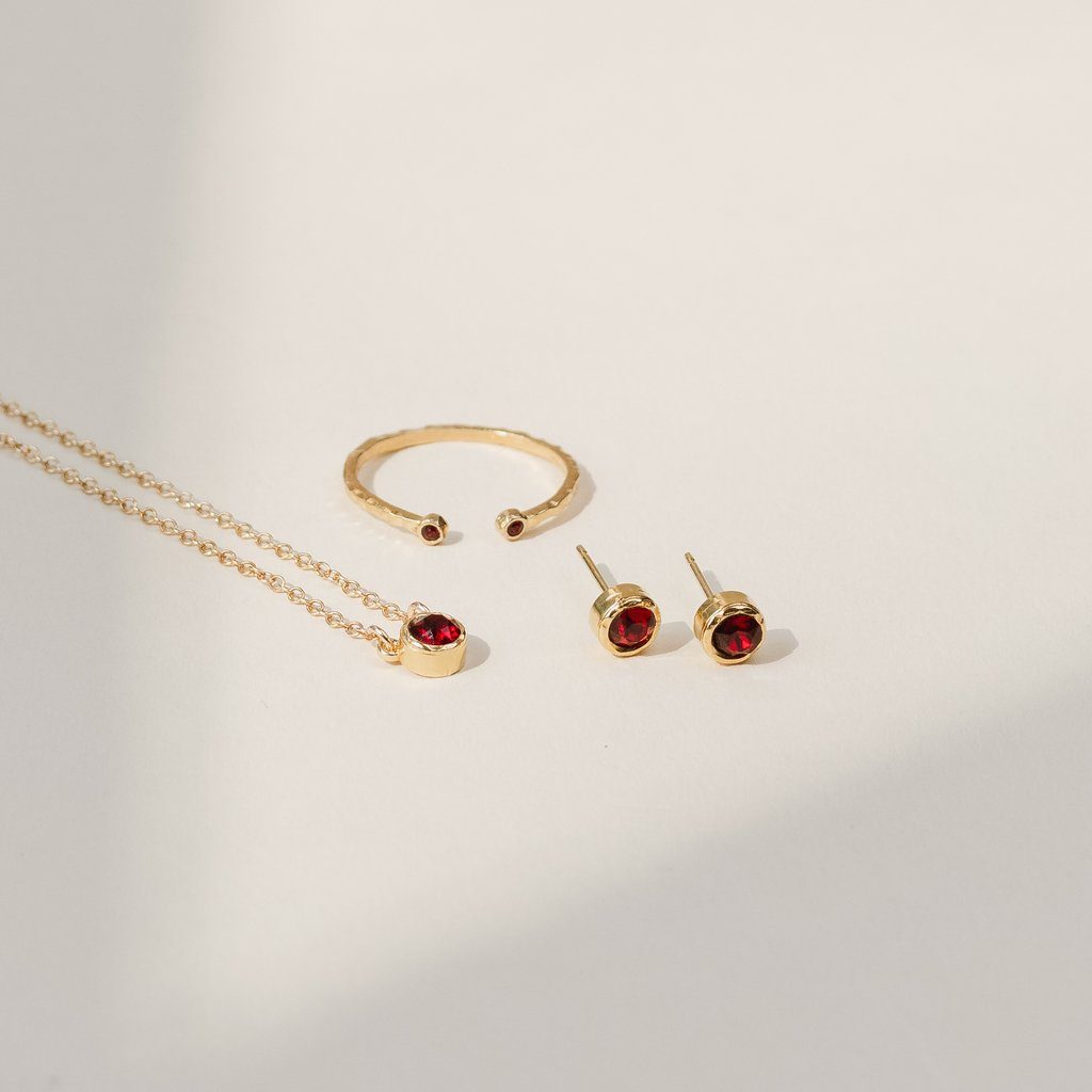 Birthstone Collection flatlay, handmade dainty gold jewelry by Katie Dean January Birthstone