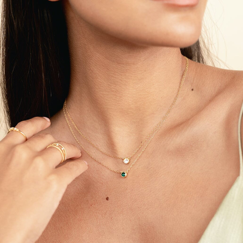 Dainty delicate May Birthstone Necklace as seen on a model. Made in the USA by Katie Dean Jewelry