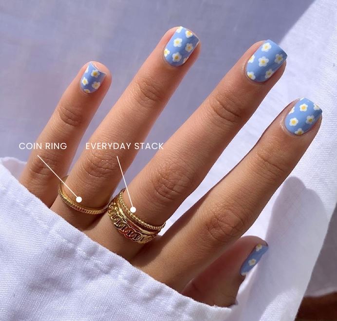 Floral nails and gold stacking rings handmade in America by Katie Dean Jewelry