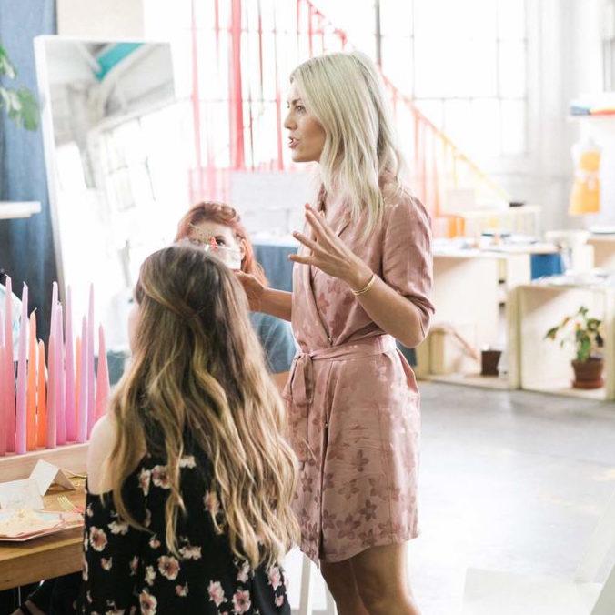 Katie Dean, entrepreneur and founder of small business katie dean jewelry, dainty handmade jewelry line, speaking at event