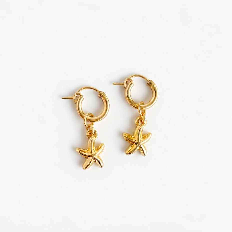 gold hoop earrings with starfish charm pendants on a white background