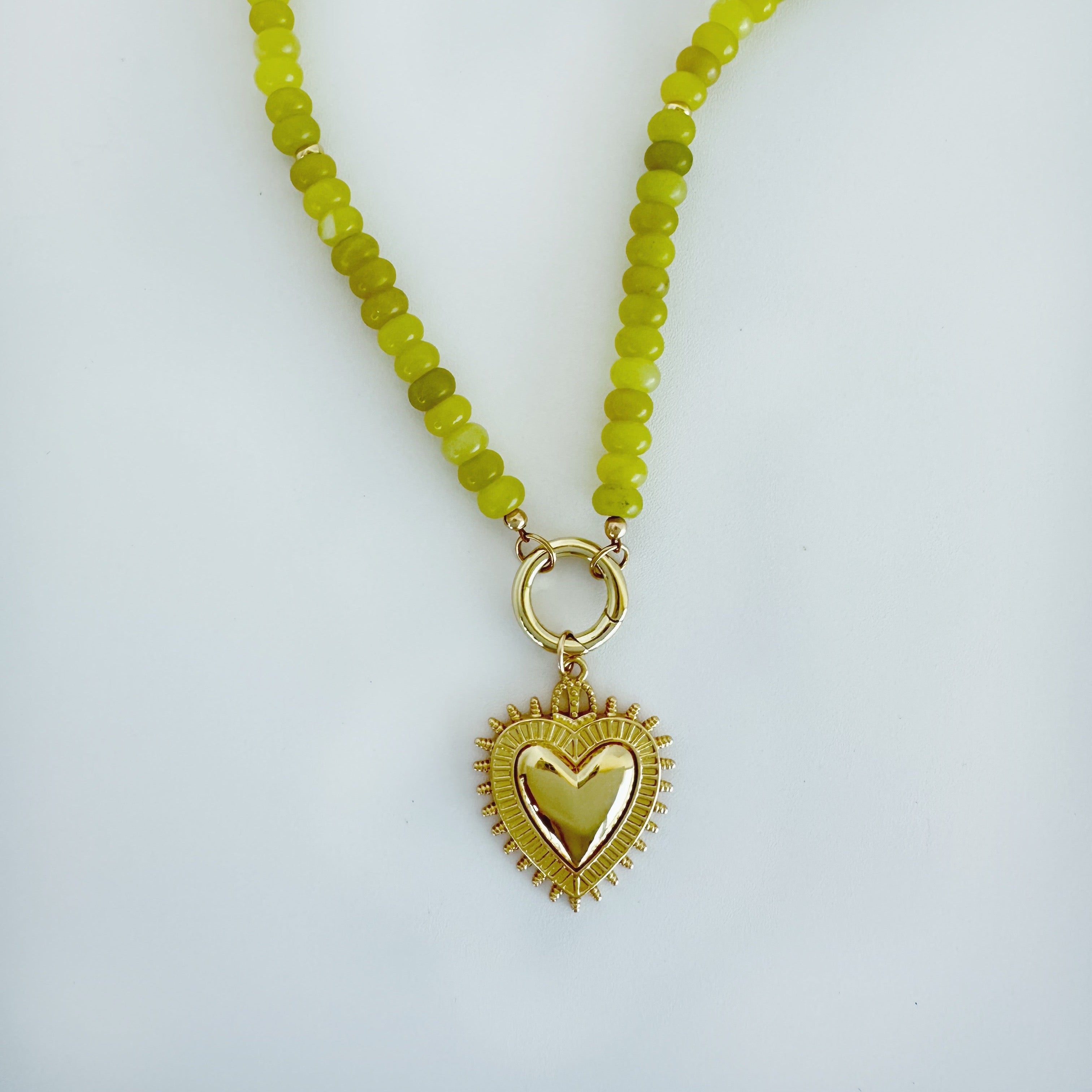 Green gemstone beaded necklace with gold fill heart charm and carabiner clasp on a white background, made by Katie Dean Jewelry.