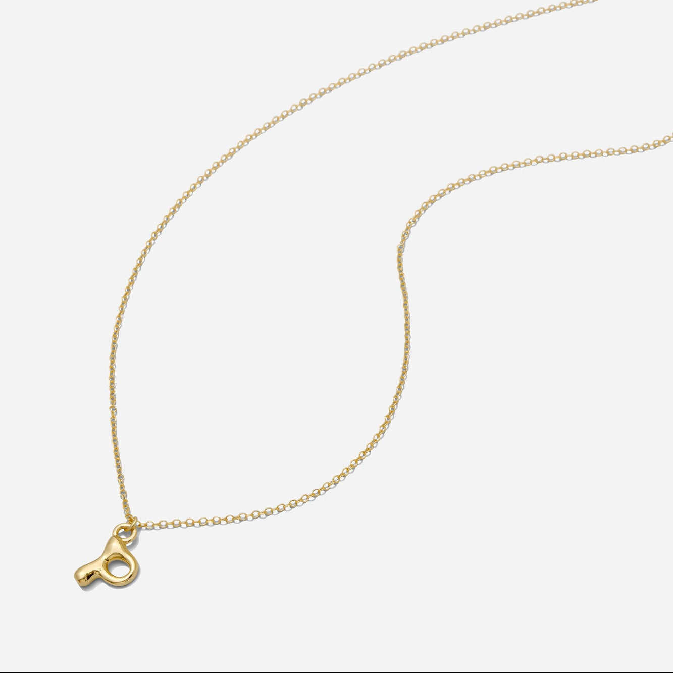 Dainty Gold puffy initial "P" pendant necklace on an 18-inch gold filled chain as seen on a white background.