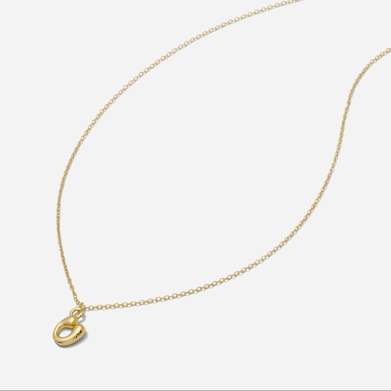 Dainty Gold puffy initial "U" pendant necklace on an 18-inch gold filled chain as seen on a white background.