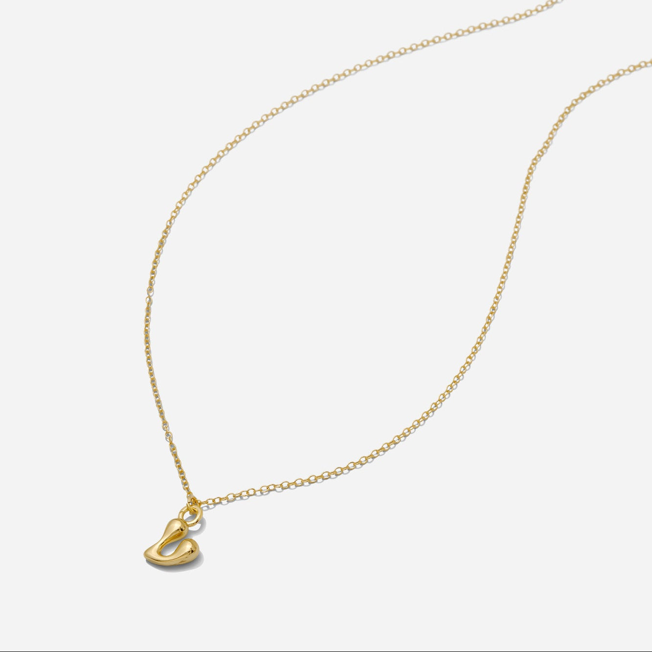 Dainty Gold puffy initial "V" pendant necklace on an 18-inch gold filled chain as seen on a white background.