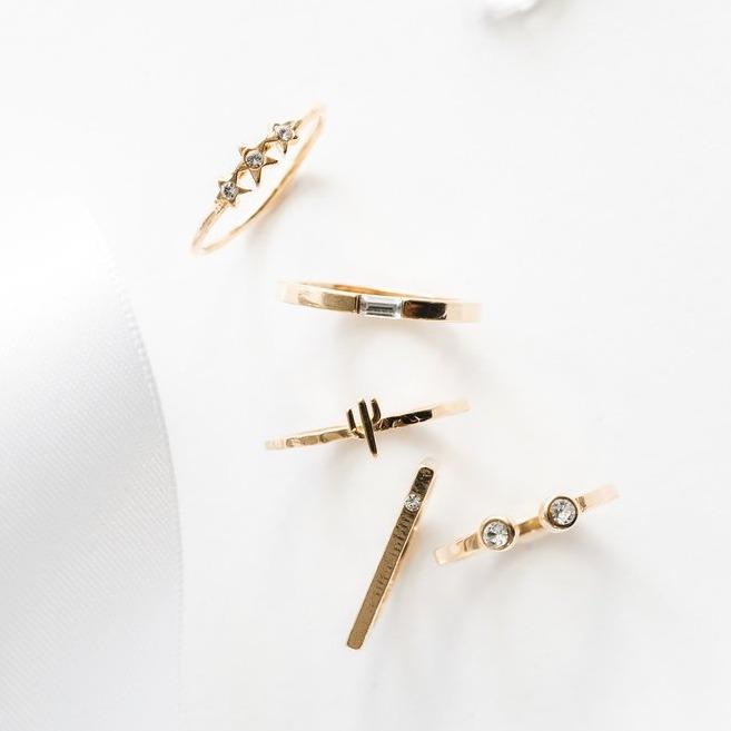 Image showing the Starburst, Baguette, Cactus, Bar with Gem, Two Gem Ring on a white background made by Katie Dean Jewelry