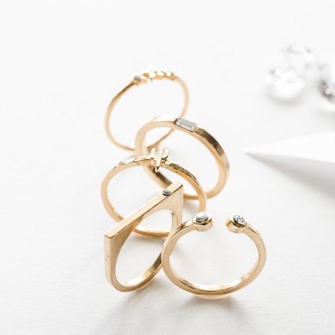 Image showing the Starburst, Baguette, Cactus, Bar with Gem, Two Gem Ring on a white background made by Katie Dean Jewelry