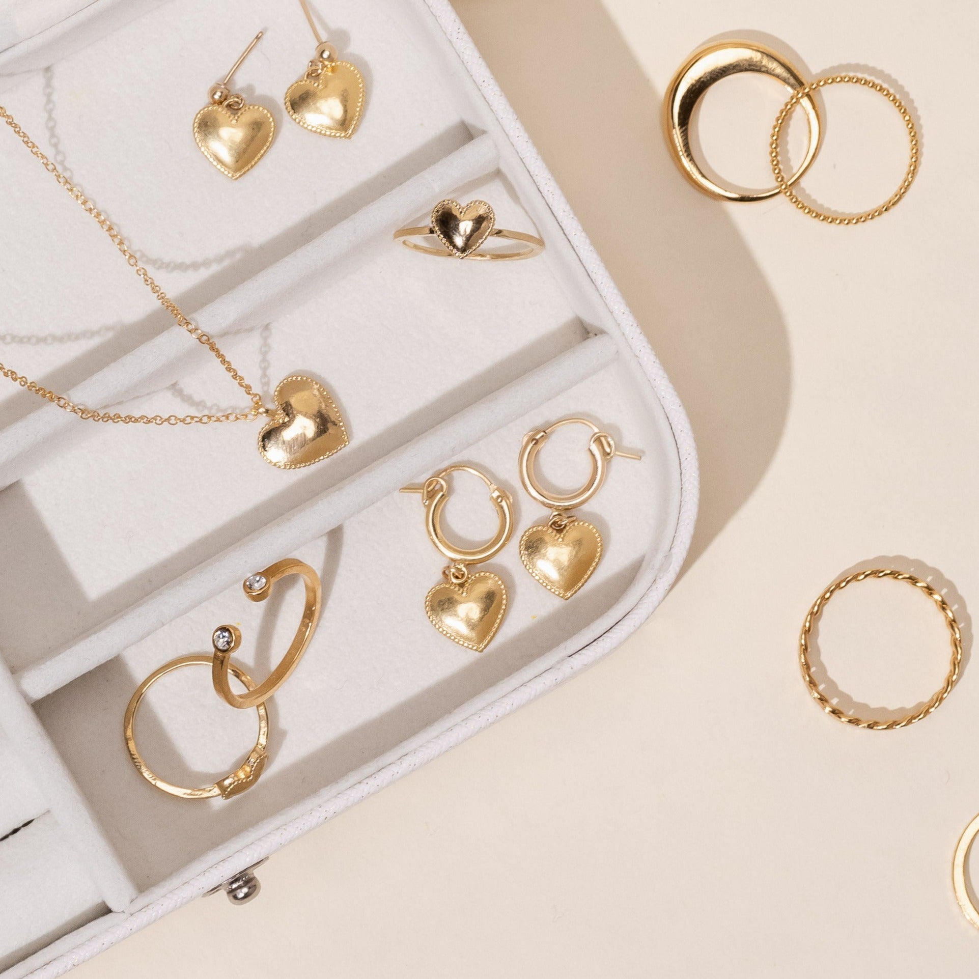 Dainty gold Heart Hoops handmade by Katie Dean Jewelry in America