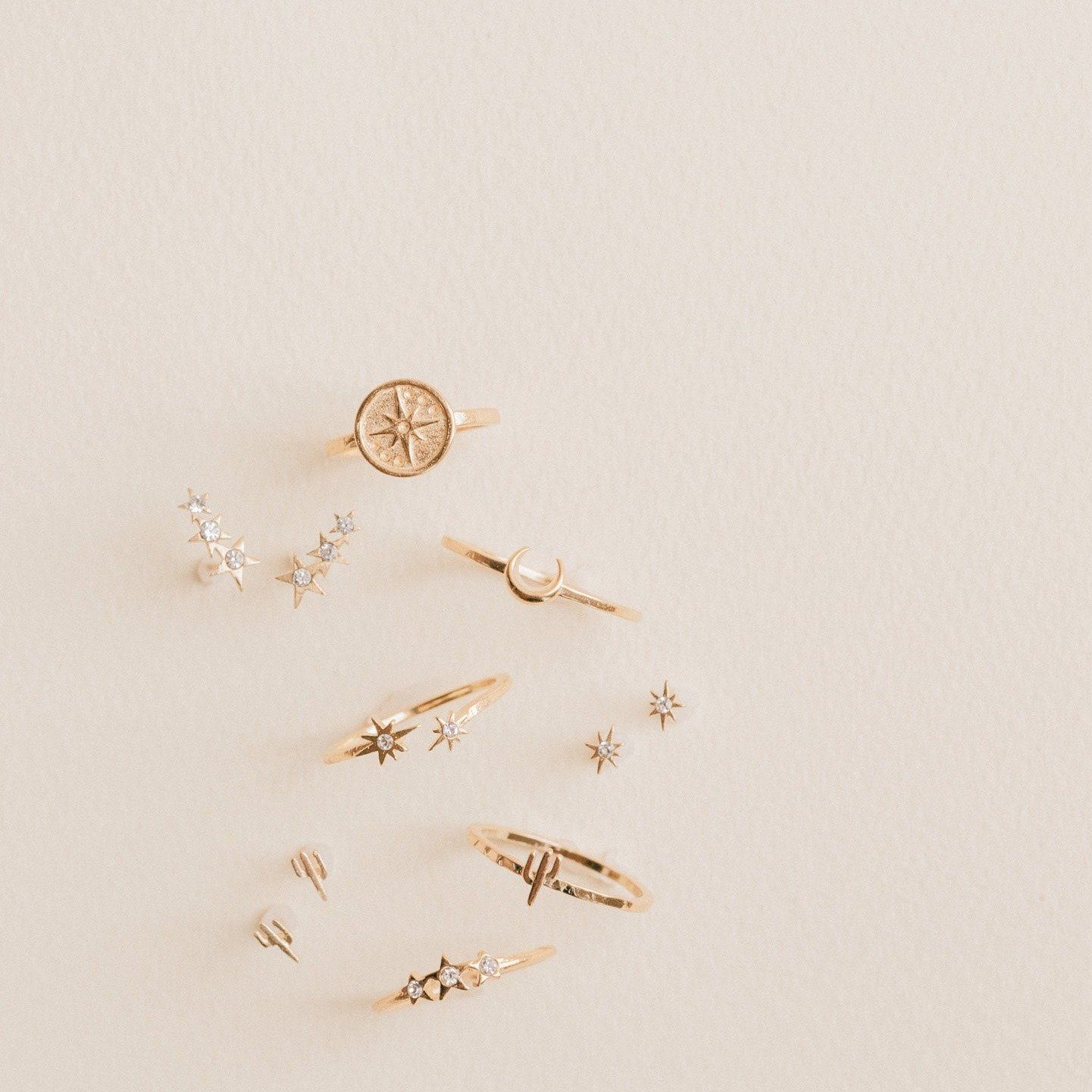 Eight pointed star ring show with other golden jewels made by Katie Dean Jewelry.