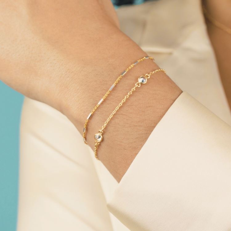 Golden Bracelet Set shown on a hand model, handmade by Katie Dean Jewelry.