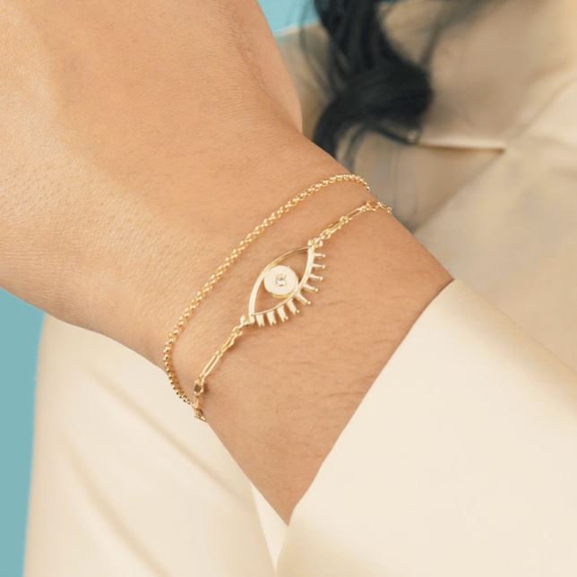 Good Vibes Evil Eye Bracelet Set shown on a hand model, handmade by Katie Dean Jewelry.