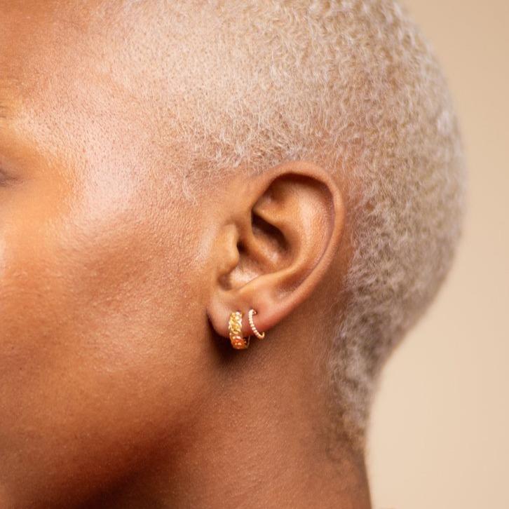 Model wearing two dainty gold hoops, Figaro Chain Hoop and Beaded Hoop Studs, designed and made by Katie Dean Jewelry