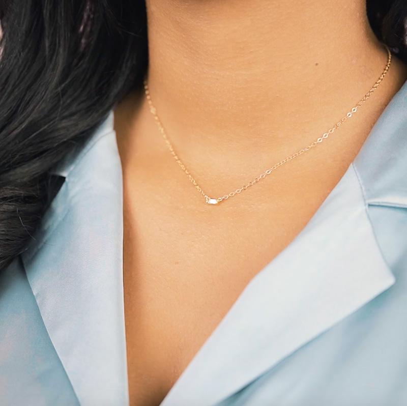 Model wearing blue silk top, looking to the side, wearing the Baguette Necklace. Handmade in California by Katie Dean Jewelry.