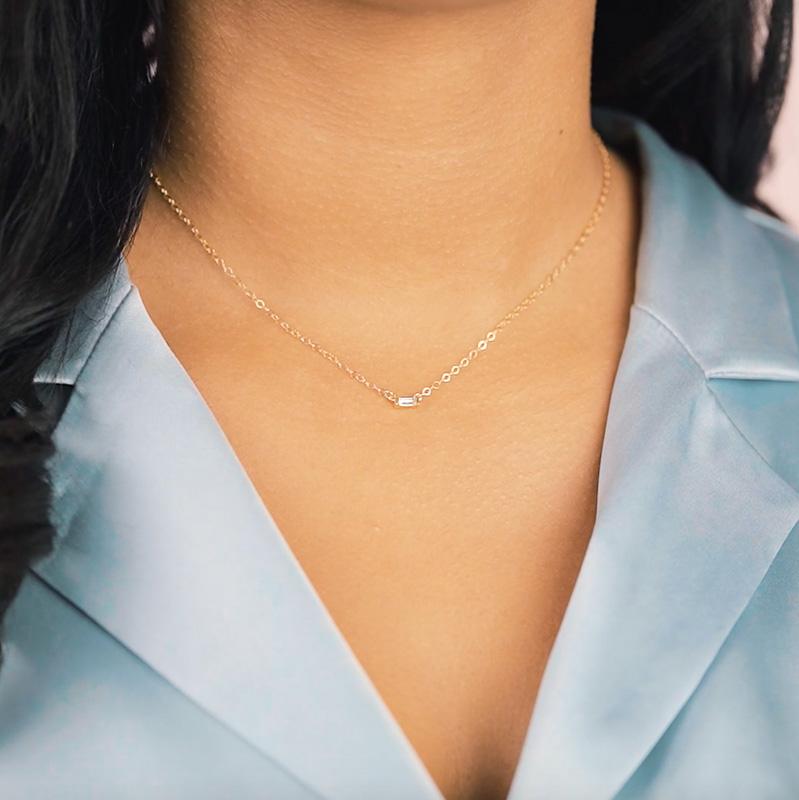 Model wearing blue silk top, looking to the side, wearing the Baguette Necklace. Handmade in California by Katie Dean Jewelry.