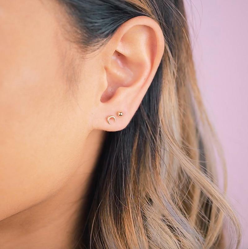 Horn or half moon, however you interpret this dainty pair, they are wonderful worn alone or stacked for those of you with double piercings. Handmade in California by Katie Dean Jewelry. Nickel free and hypoallergenic.