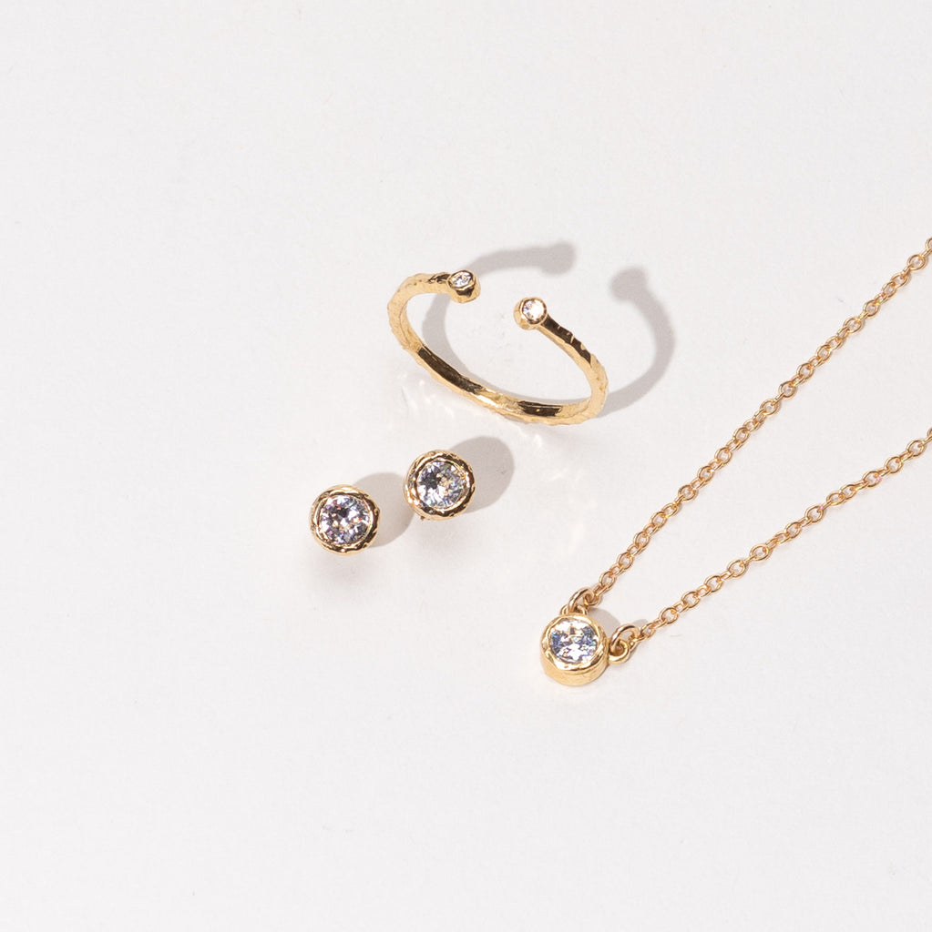 Dainty, delicate gold April Birthstone necklace, earrings and ring from the Birthstone Collection. Minimalist jewelry made in America by Katie Dean Jewelry