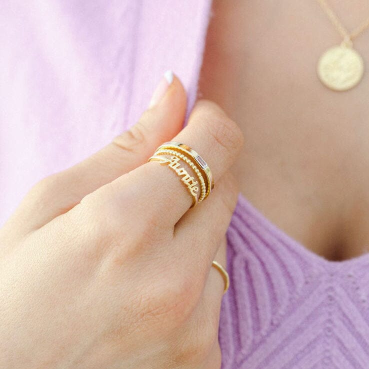 Gold Auntie Ring stacked with two other gold rings, all made in America by Katie Dean Jewelry