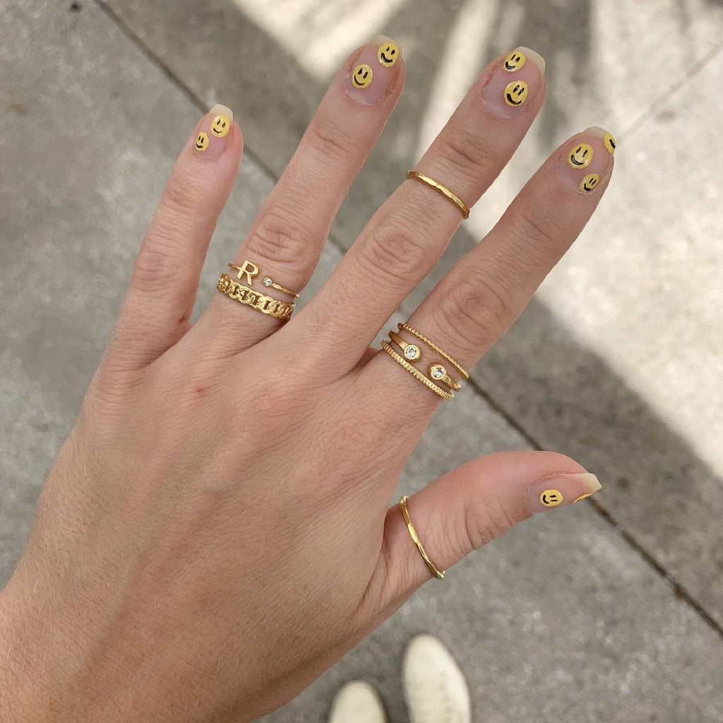 Smiley face nails with dainty gold rings by Katie Dean Jewelry