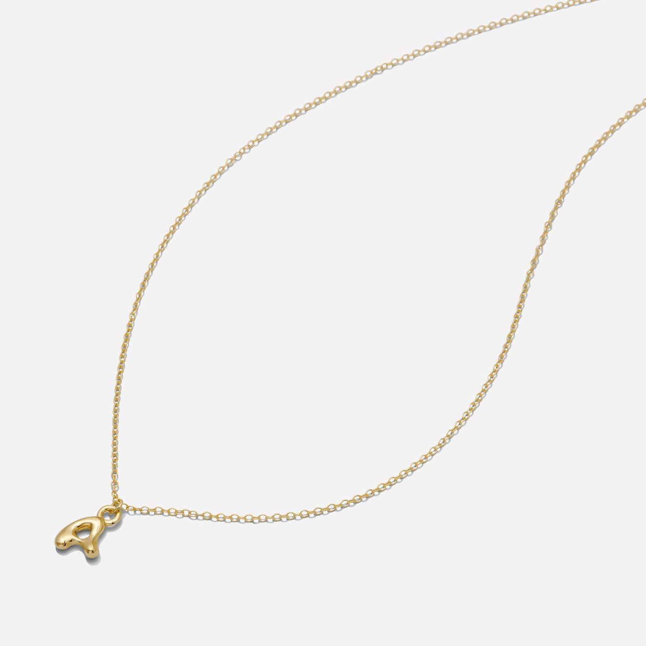 Dainty Gold puffy initial "A" pendant necklace on an 18-inch gold filled chain as seen on a white background.