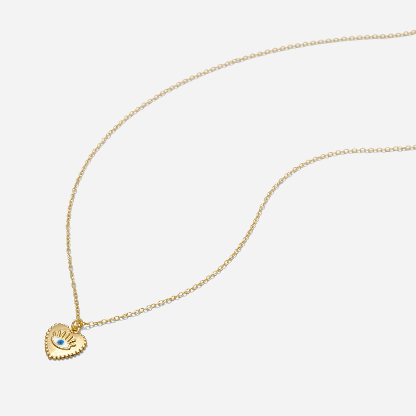 Gold necklace with a heart-shaped pendant on a white background, made by Katie Dean Jewelry.
