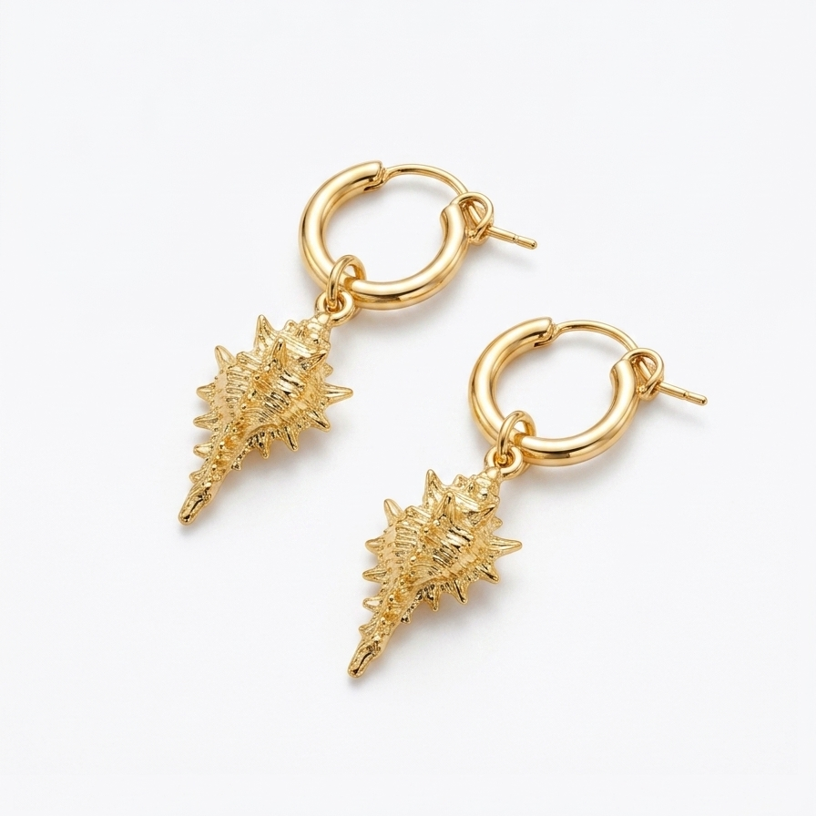 gold hoop earrings with detailed conch shell charms on white background