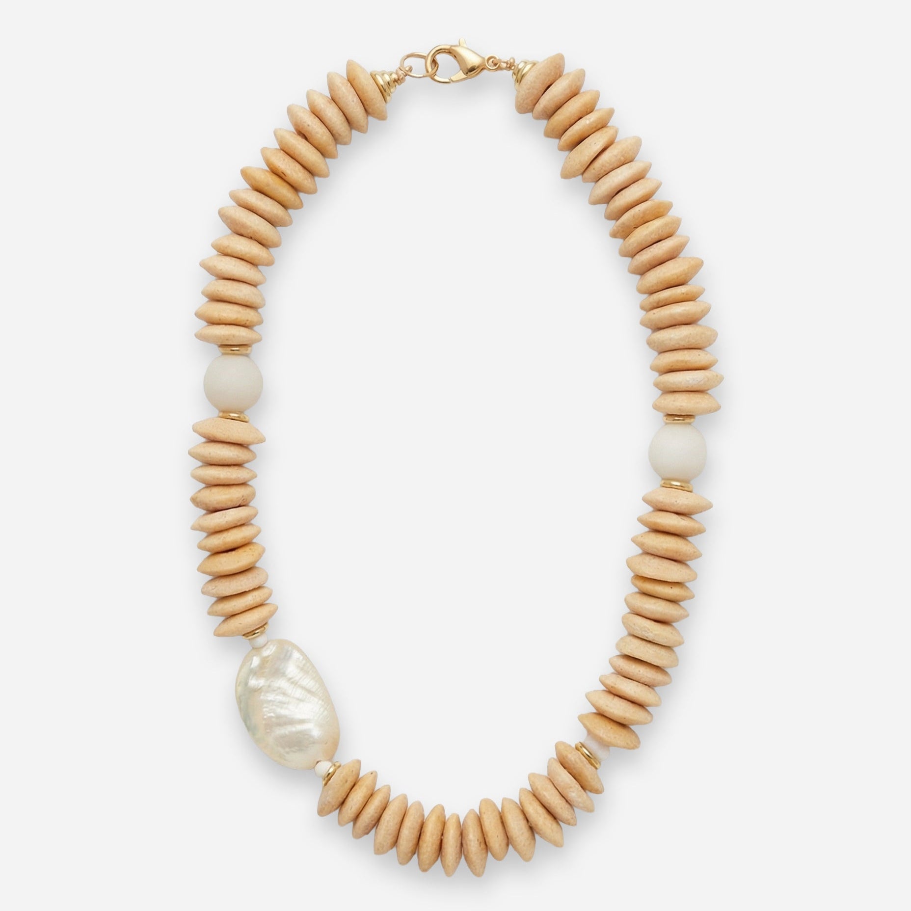 Necklace with cream beads and a large shell pendant on a white background