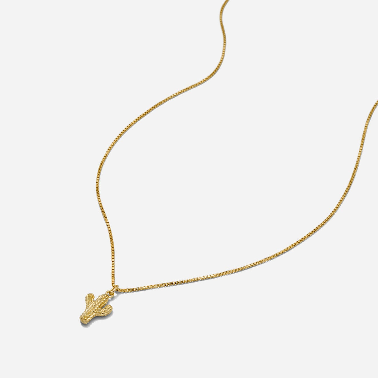 Desert gold cactus pendant necklace by Katie Dean Jewelry on a white background.