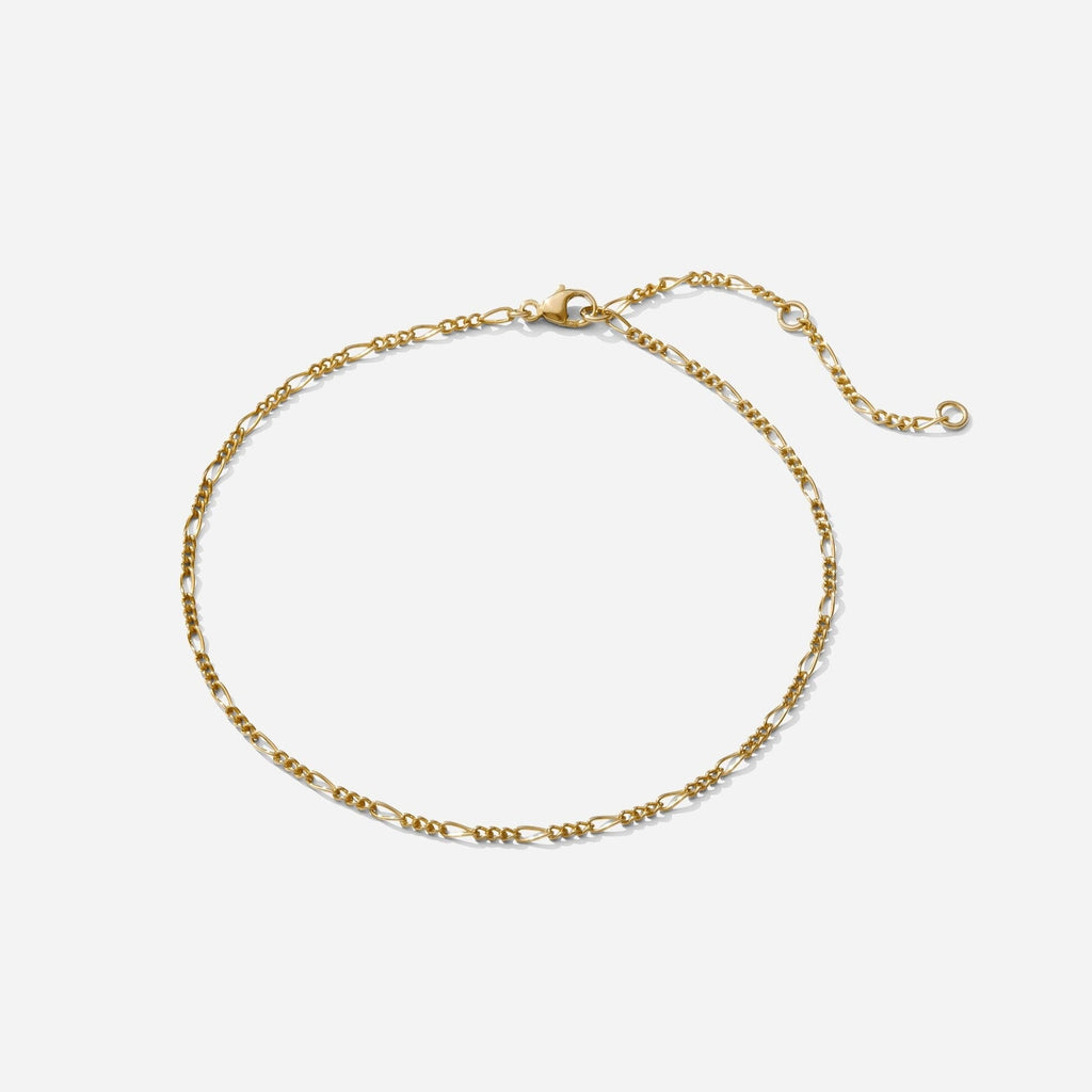 The gold Figaro Chain Anklet as seen on a white background by Katie Dean Jewelry. Made in America.