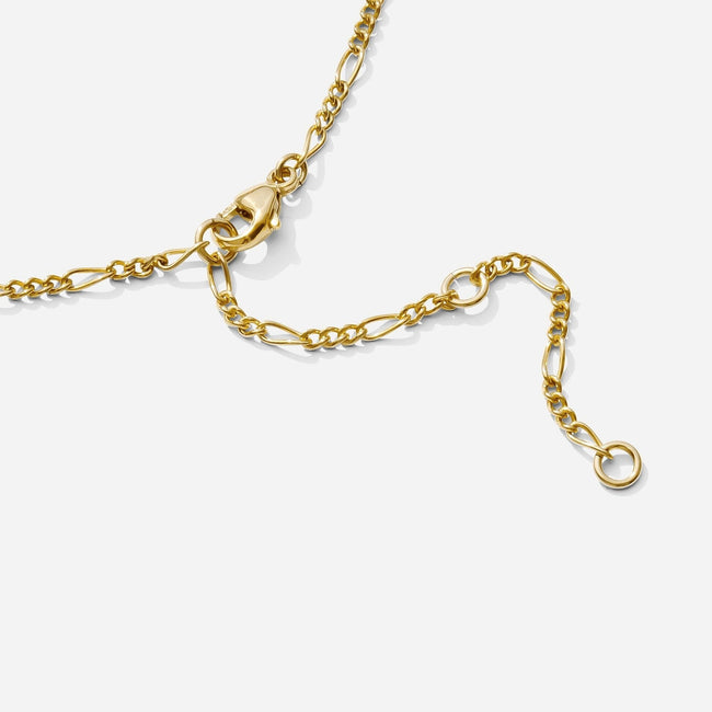 The end of the gold Figaro Chain Anklet, showing three different places to clasp the end, as seen on a white background by Katie Dean Jewelry. Made in America.