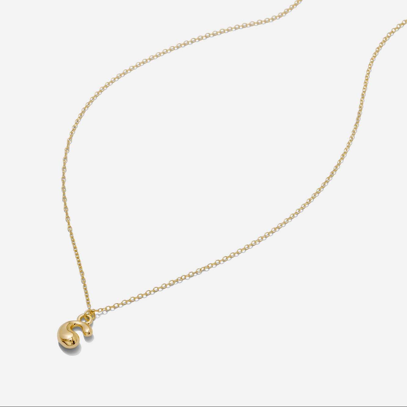 Dainty Gold puffy initial "G" pendant necklace on an 18-inch gold filled chain as seen on a white background.