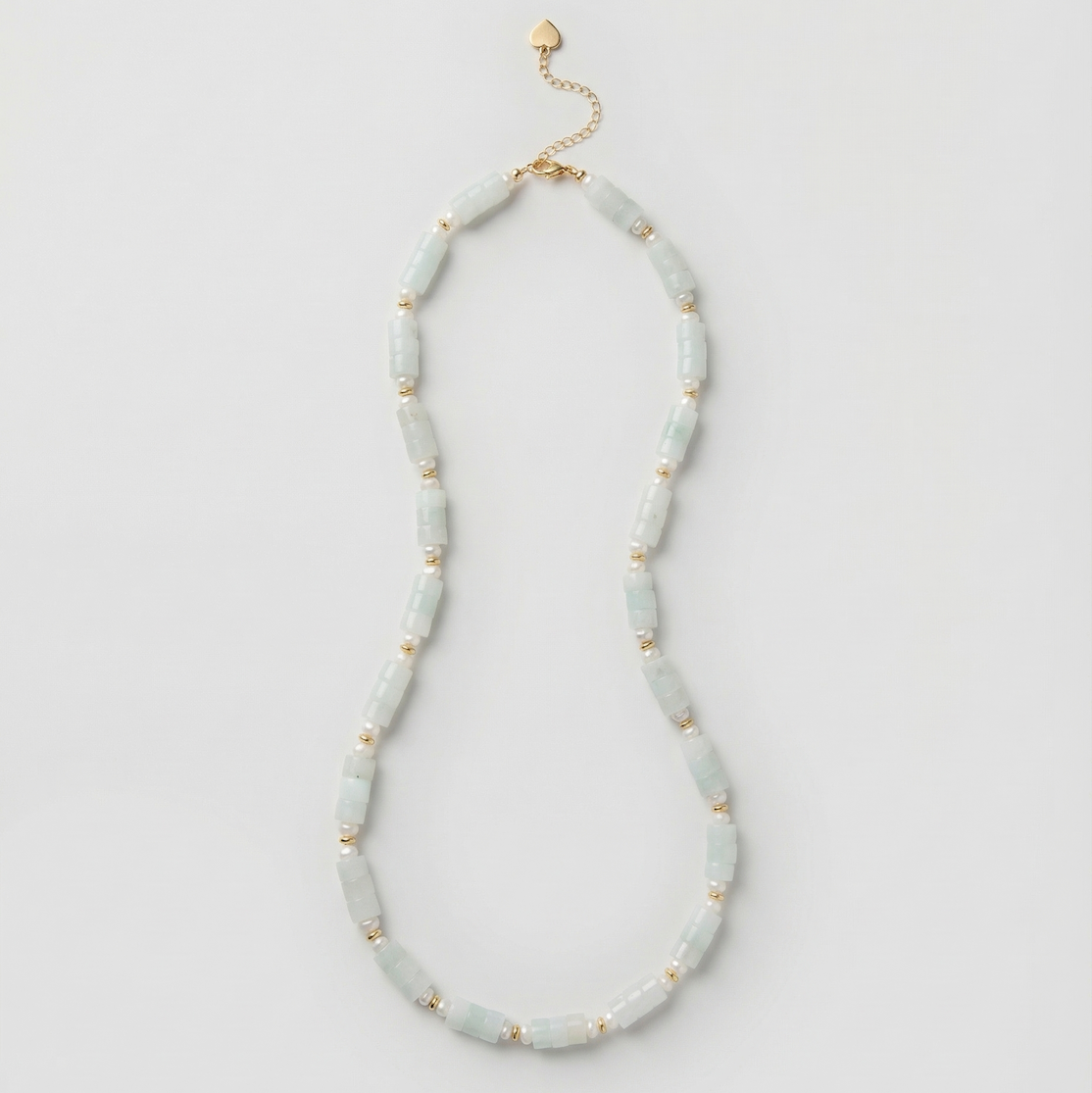 Neutral heishi bead necklace in light blue with gold accents and extension chain