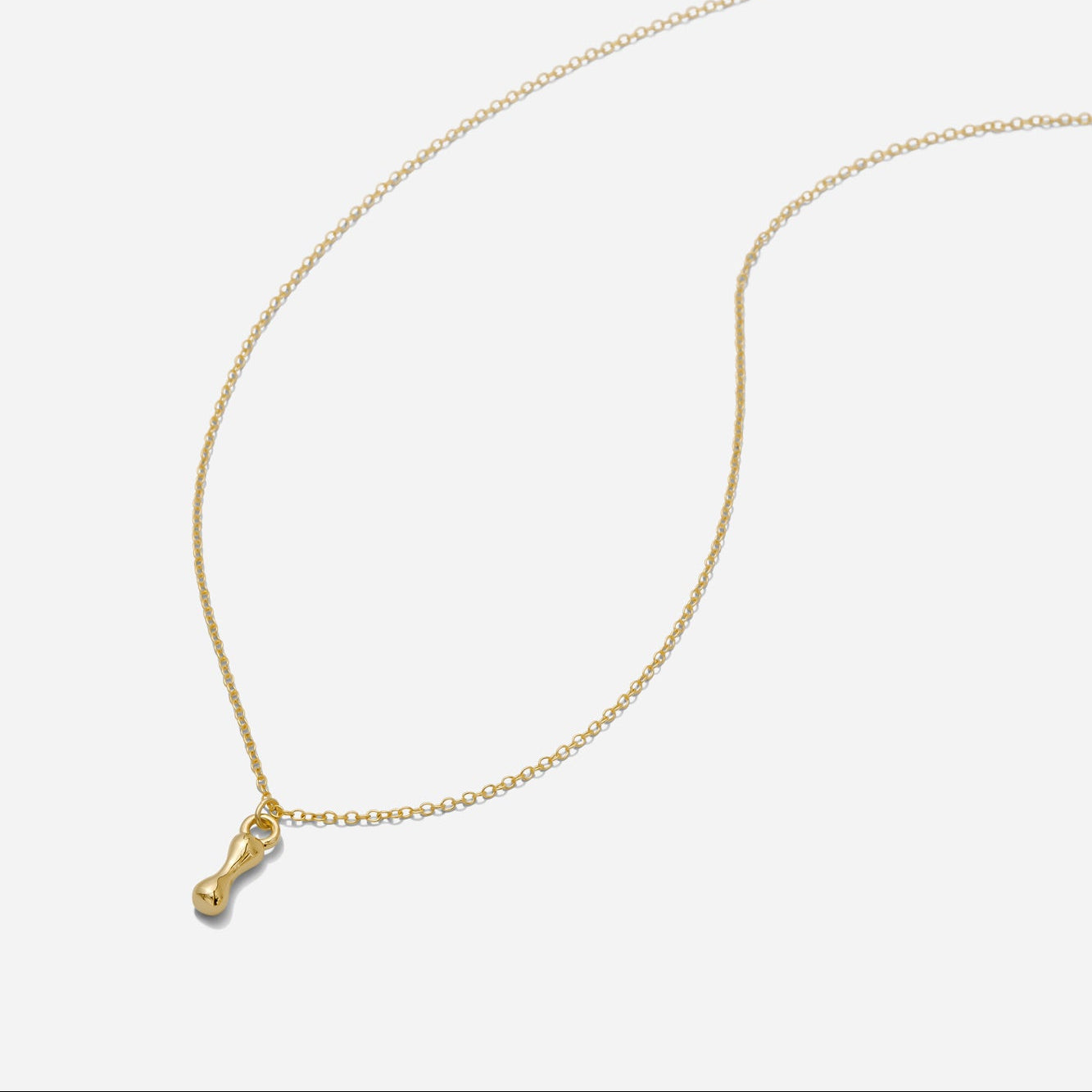 Dainty Gold puffy initial "I" pendant necklace on an 18-inch gold filled chain as seen on a white background.
