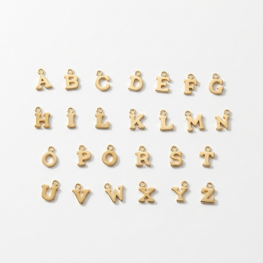 Gold initial charms on a white background.