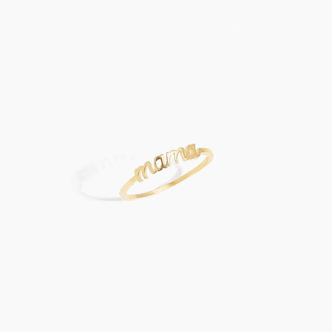 Dainty gold stacking Mama Ring as seen on a natural white background.