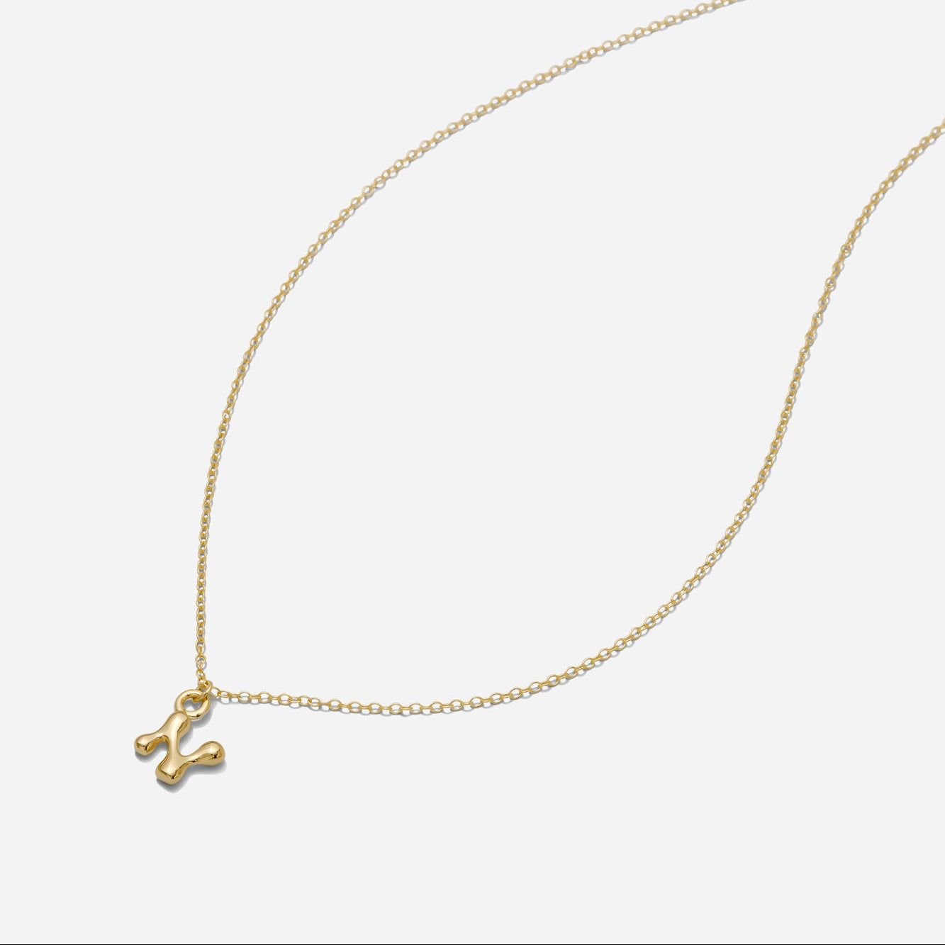 Dainty Gold puffy initial "N" pendant necklace on an 18-inch gold filled chain as seen on a white background.