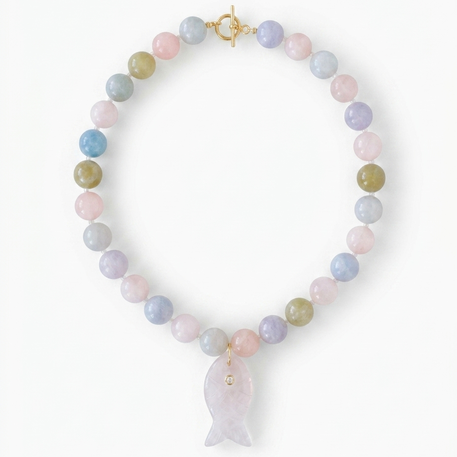 Necklace with pastel beads and a light pink fish charm on a white background