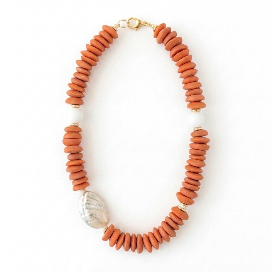 Necklace with orange beads and a gold clasp on a white background