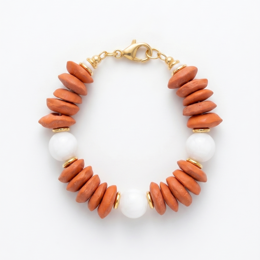 Bracelet with orange and white beads on a white background