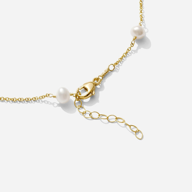 The end of the gold Pearl Anklet, showing clasp and extension chain, as seen on a white background by Katie Dean Jewelry. Made in America.