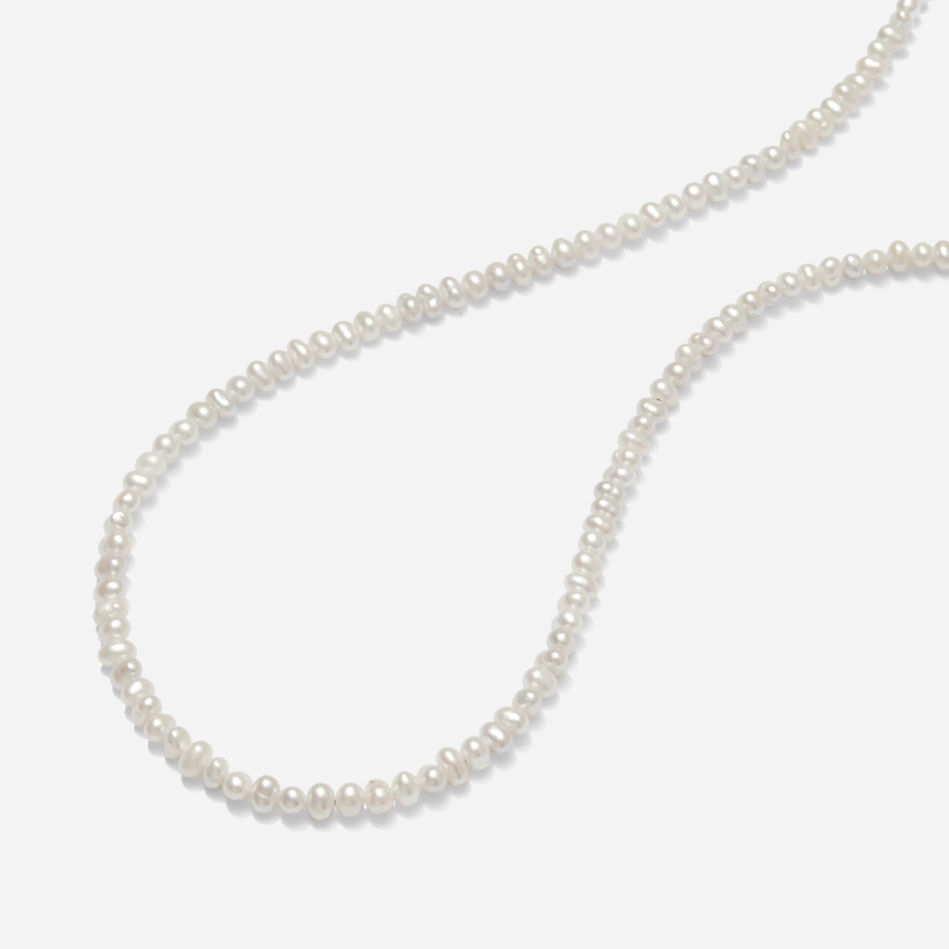 Pearl necklace on a white background hand beaded by Katie Dean Jewelry in America.
