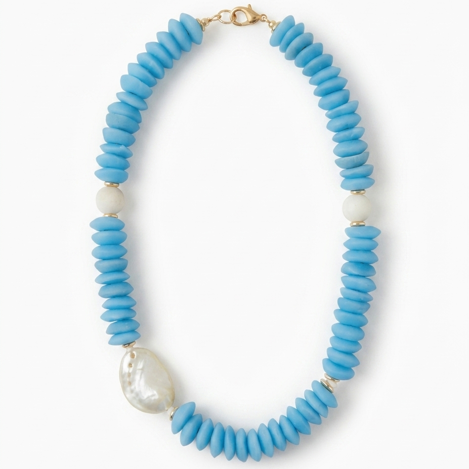 Necklace with blue beads and an abalone shell on a white background