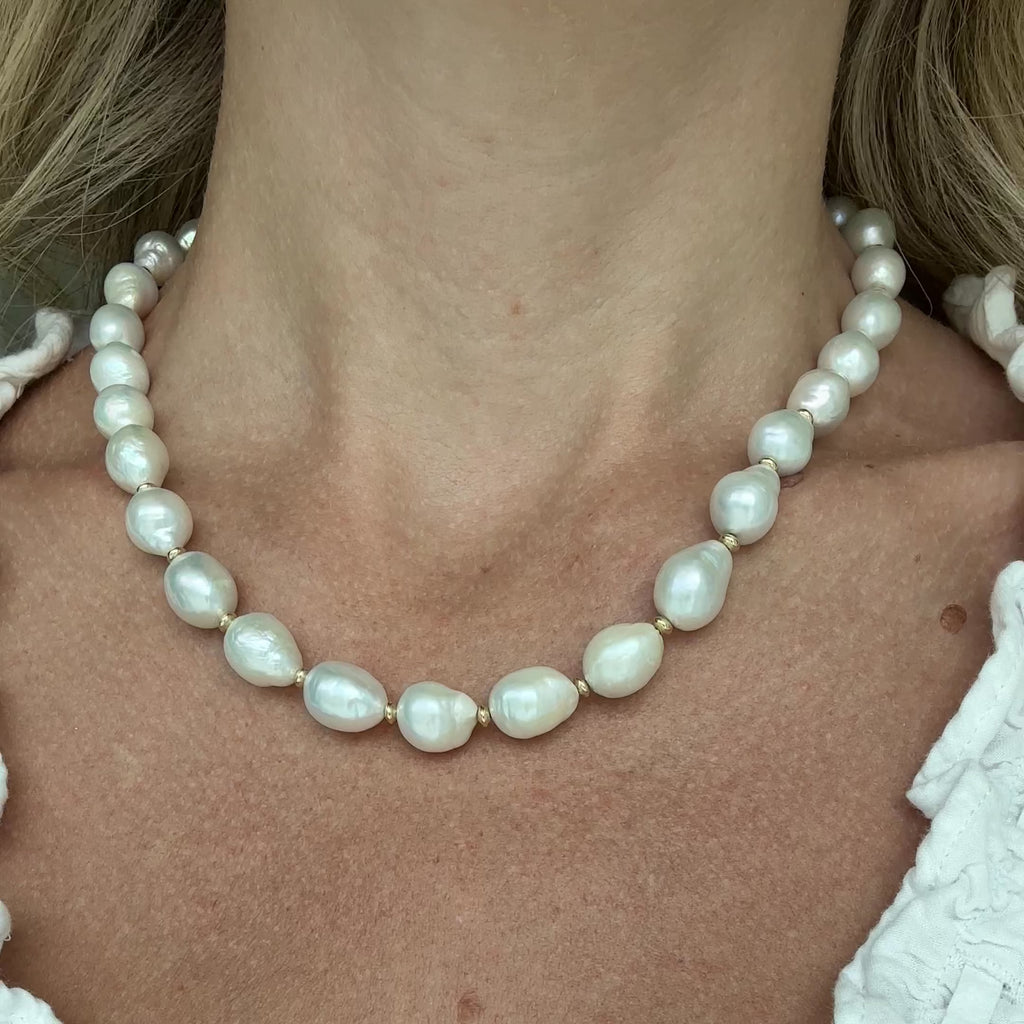 Woman wearing a pearl necklace.