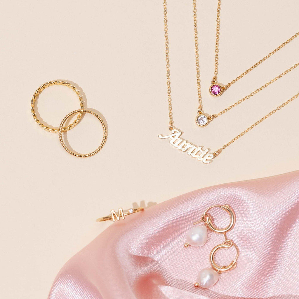 Dainty gold Auntie Necklace layered with the October Rose Birthstone Necklace, Pearl Hoops and Initial Ring, handmade in America by Katie Dean Jewelry