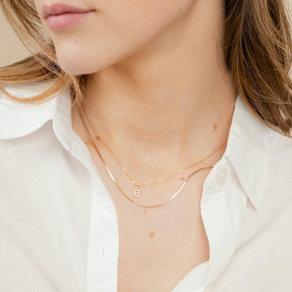 The Herringbone Chain shining brightly layered with the Initial Necklace, handmade by Katie Dean Jewelry