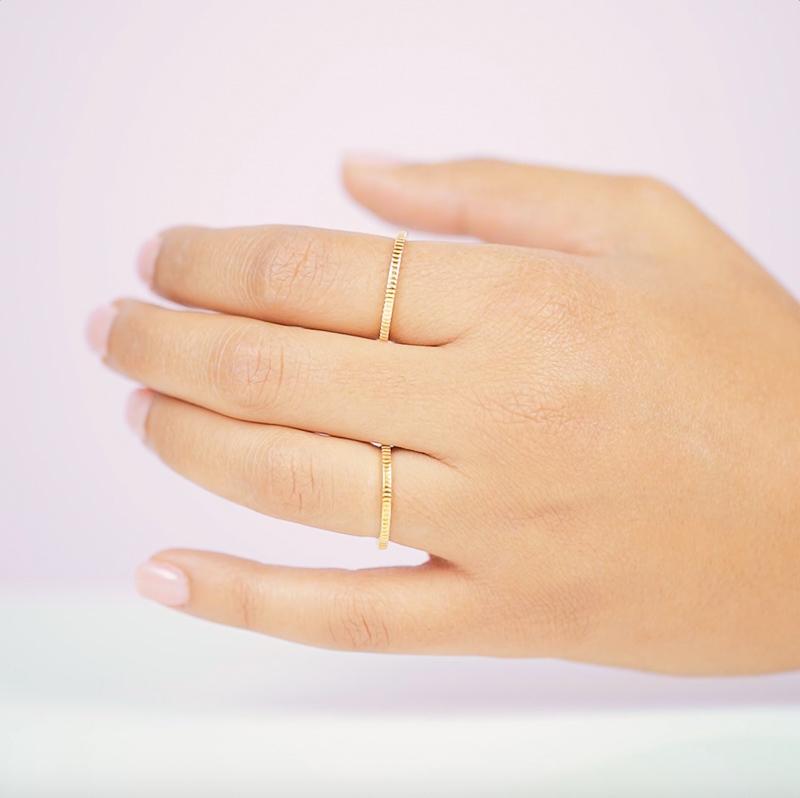 Putting a twist on the classic band ring with some intricate coin details. Perfect for your next stacking ring.