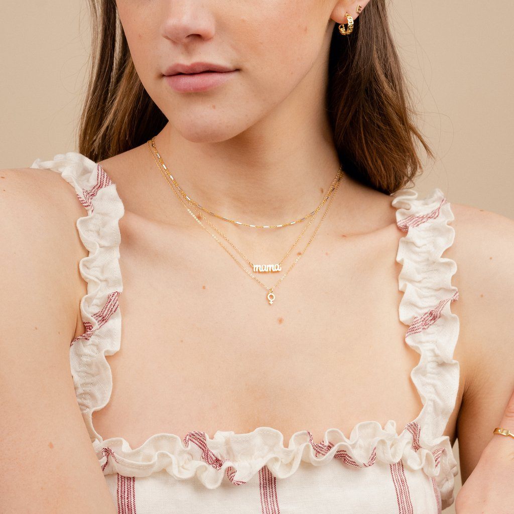 Dainty gold Mama Necklace layered with the Silver and gold Choker, and the Female Symbol Necklace by Katie Dean Jewelry